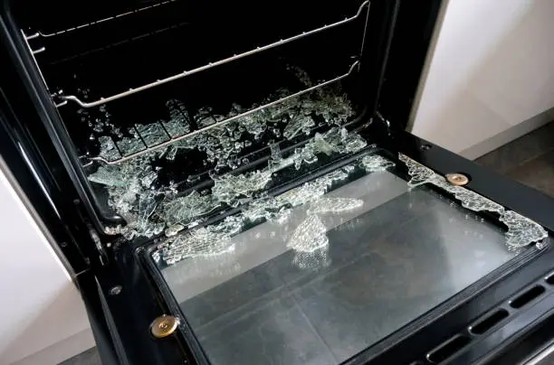Broken oven door showing common appliance problem requiring repair service